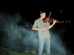 The son of one of our friends playing his fiddle at the camp fire, Dunromen Camp Ground, Annapolis Royal, Nova Scotia.